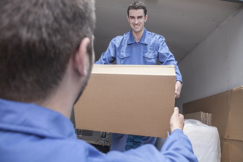 Local movers handling boxes in a riverside apartment building in Rotherhithe