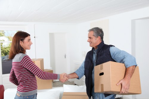 Careful transport of household items from a riverside apartment