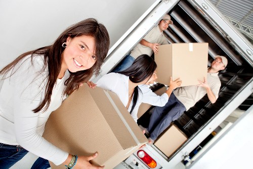Packed moving boxes and furniture ready for house removals