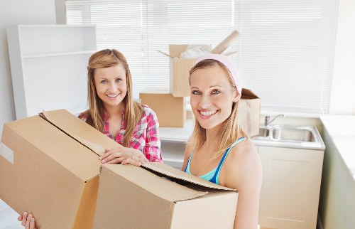Professional movers loading items for a flat move