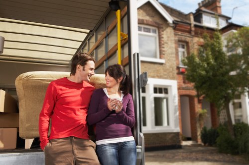 Movers carrying household items through a local property